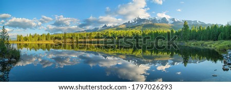 Picturesque mountain lake in the summer morning, Altai. Beautiful reflection of mountains, sky and white clouds. Royalty-Free Stock Photo #1797026293