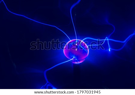 Visible energy caused by a high voltage discharge tube filled with an inert gas. Beams of energy on detail. Royalty-Free Stock Photo #1797031945