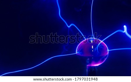 Visible energy caused by a high voltage discharge tube filled with an inert gas. Beams of energy on detail. Royalty-Free Stock Photo #1797031948