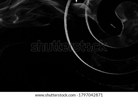 Close up of smoke from mosquito repelling coil.