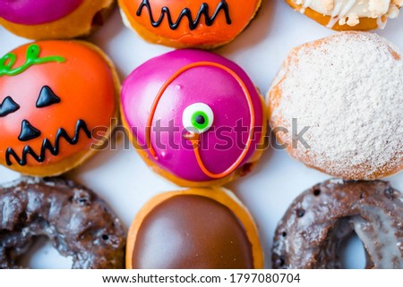 Delicious, colorful donuts decorated for the Halloween holiday. The view from the top.