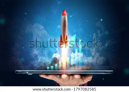 The inscription start-up, the rocket taking off on the background image of the development strategy charts, business concept, new technologies. Copy space