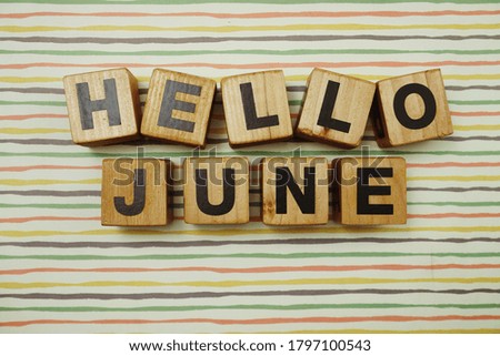 Hello June alphabet letters on colorful stripes background
