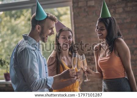 Having a party. Young adults drinking alcohol at the birthday party