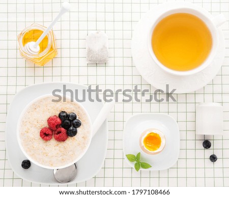 Healthy  Breakfast with oatmeal, boiled egg and herbal tea, lifestyle, top view