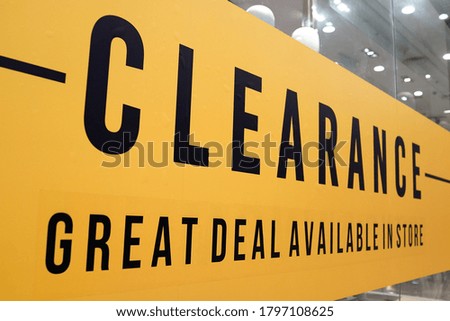Large Clearance letters on a glass wall obstruct a view inside the popular fashion store.               