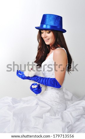 Bride with a rabbit in a blue hat and blue gloves