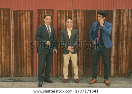 Portrait of Persian businessmen together in the streets outdoors