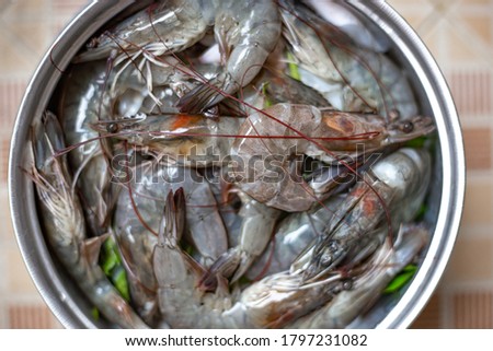 Top view of cooking shrimp or prawn and squid in pot steam in kitchen. Seafood menu. Selective focus. Soft picture