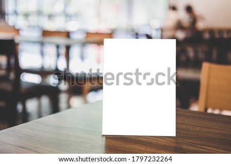 Mock up acrylic frame posters pattern template forms background, blank menu frame on table in coffee shop or restaurant stand for your text of display your product.