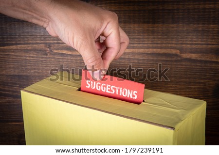 SUGGESTIONS. Work environment, customer service, improvement and sales concept. Hand of a voter putting vote in the ballot box Royalty-Free Stock Photo #1797239191