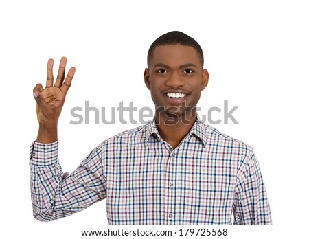 Closeup portrait of young handsome, smiling business man giving three fingers sign gesture with hands, isolated on white background. Positive human emotions, facial expressions, feeling, signs, symbol