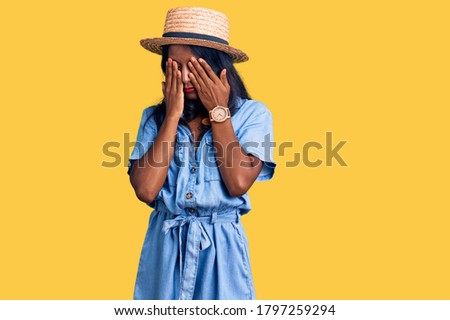 Young indian girl wearing summer hat rubbing eyes for fatigue and headache, sleepy and tired expression. vision problem 