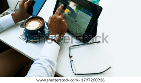 Caucasian Businessman Using Digital Tablet In Cafe