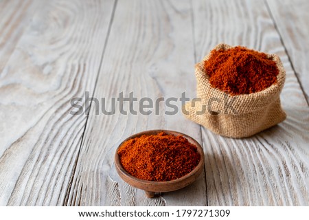 Berbere is the main part in the cuisines of Ethiopia and Eritrea. A mixture of spices, usually including red pepper, ginger, cloves, coriander, allspice. Wooden background. Royalty-Free Stock Photo #1797271309