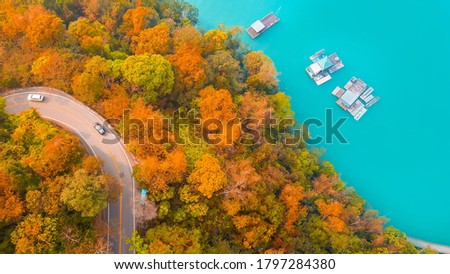 Aerial Drone Photography top view road going Road through autumn forest at Sun Moon Lake in Taiwan.