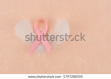 The month of feminine breast cancer awareness,use the sign of pink ribbon concept to share the symbol of hope, survivor, cure, fight. The bow is on copy space to write on campaign of treatment cancer 