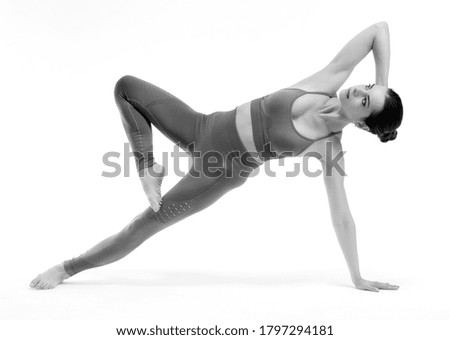 Fitness woman doing yoga exercise on white background