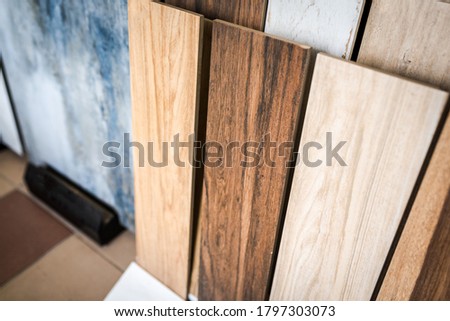 Variety of wooden like tiles. Samples of fake wood tiles for flooring. Assortment of floor laminate / tiles in an interior shop. Royalty-Free Stock Photo #1797303073