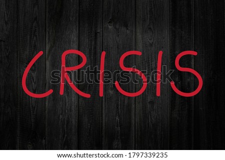 crisis written on black wood, concept of global crisis caused by the coronavirus pandemic