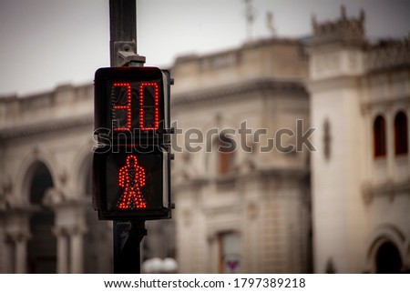 A digital don't walk sign at a cross walk indicates there are thirty seconds to wait before crossing a street in Lima, Peru.