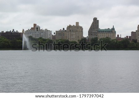 The skyline of Manhattan seen from over the reservoir in Central Park.