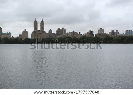 The skyline of Manhattan seen from over the reservoir in Central Park.