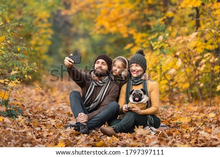 holidays, vacation, travel and tourism concept - group of friends or couples having fun in autumn park and taking selfie