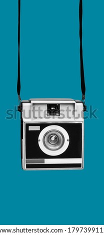 a retro film camera, in black and white, on a blue background, in a vertical format to use for mobile stories or as smartphone wallpaper