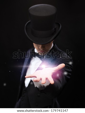 magic, performance, circus, show and advertisement concept - magician holding something on palm of his hand Royalty-Free Stock Photo #179741147