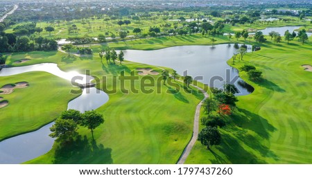 Aerial view of green grass and trees on a golf field, fairway and putting green top view, Bangkok Thailand. bird view over Golf course in the tropical Bangkok. Royalty-Free Stock Photo #1797437260