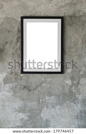 Empty photo frame hanging on gray grungy cement wall