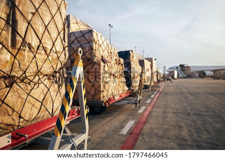 Loading of cargo containers to airplane at airport.  Royalty-Free Stock Photo #1797466045