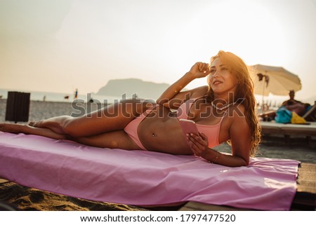 An attractive young woman enjoying a vacation at the beach