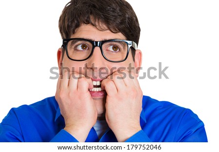 Closeup portrait of nerdy young guy with black glasses biting his nails, looking funny, scared, craving something, anxious, isolated on white background. Human facial expressions, emotions, feelings