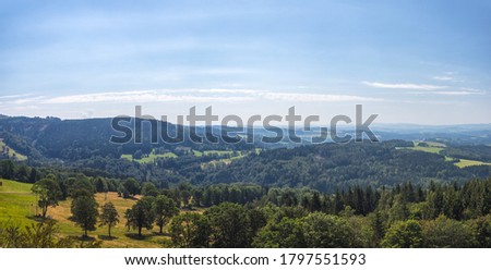 beautiful landscape with hills and forests, blue sky with clouds