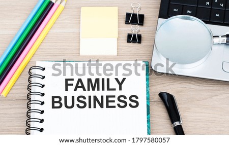 FAMILY BUSINESS concept write text on notepad