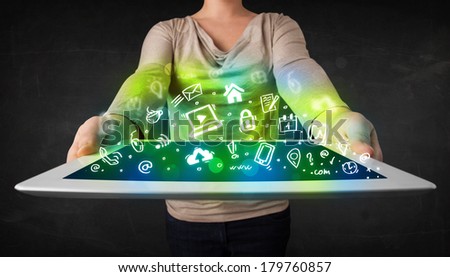 Person holding tablet pc with green media icons and symbols