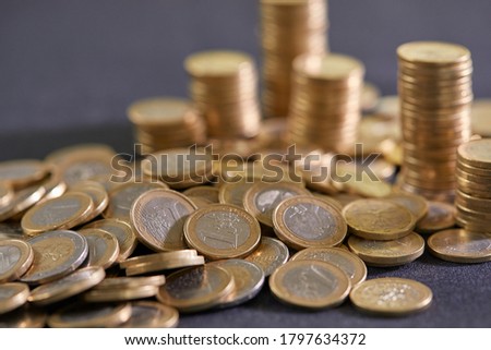 Stock Photo - Euro coins. Euro money. Euro currency.Coins stacked on each other in different positions. Money concept