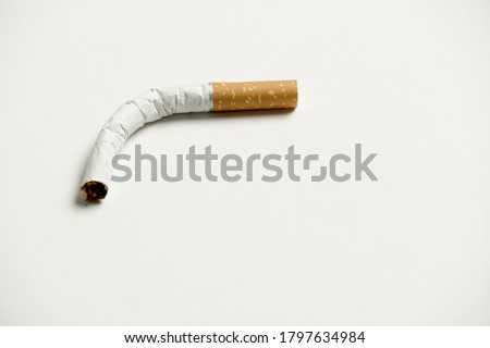 folded cigarette in a white back ground. impotence concept. flat lay Royalty-Free Stock Photo #1797634984