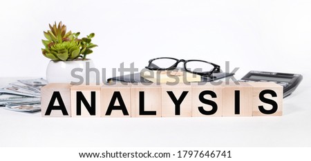 The word "yes" is written in black letters on wooden blocks. Spell message yes on red background on white paper. Plant business, motivation and education concept near magnifier, glasses, paper clip cu