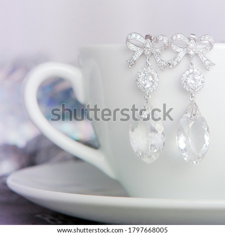 The bride's tender morning - earrings with large stones on the edge of a white cup