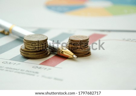 pen and calculator on a financial graphic. financing. High quality photo