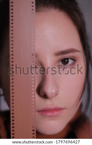 brunette wrapped in a film reel or film strip