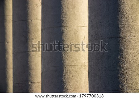 Elements of architectural decorations of buildings, columns and tops, gypsum stucco molding, wall texture and patterns. On the streets in Minsk, public places.