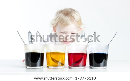 little girl during Easter eggs' coloration