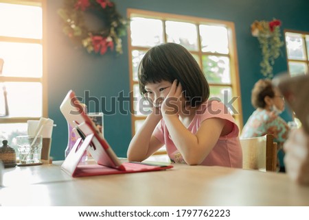 asian children watching tablet, kid playing phone and looking at cartoon
