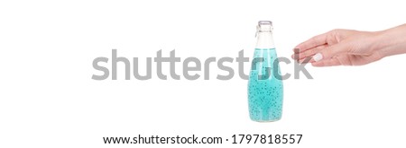 Hand with exotic vegeterian drink with basil seeds. Isolated on white background, copy space template, banner.