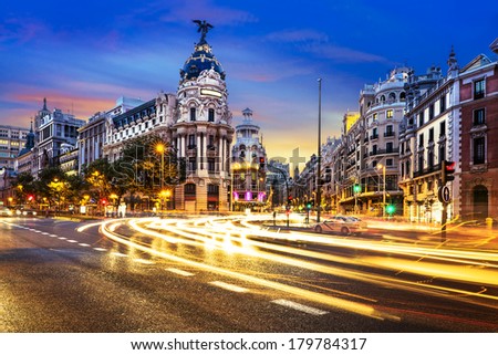 Rays of traffic lights on Gran via street, main shopping street in Madrid at night. Spain, Europe.  Royalty-Free Stock Photo #179784317