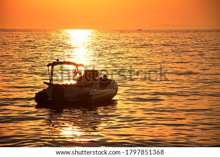 Scenic sunset on Adriatic sea with boat sailing